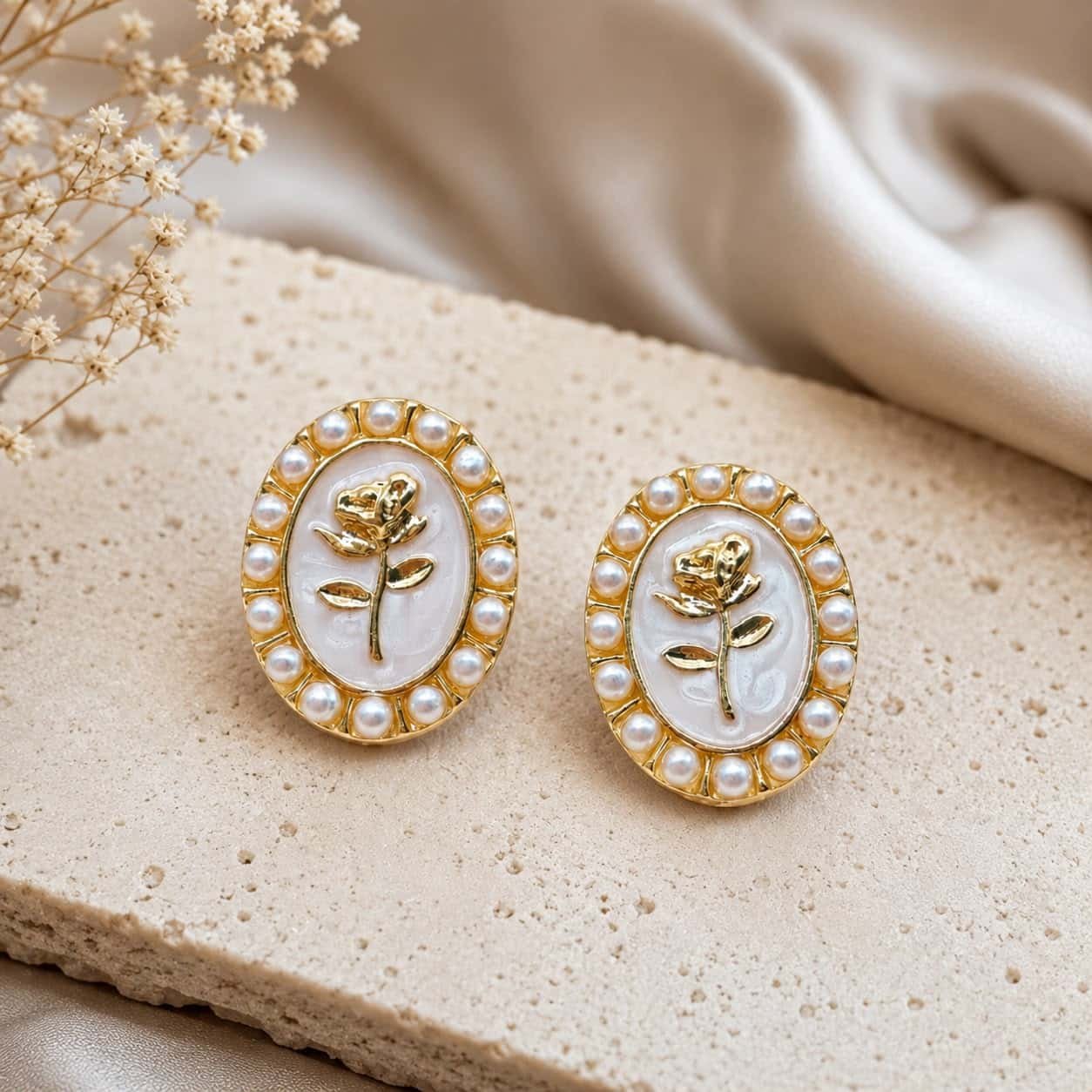 Vintage rosette stud earrings with golden rose design and pearl detailing